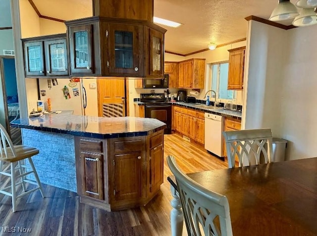 1711 Hardins Run Rd, New Cumberland, WV 26047 - kitchen with black appliances, wood finished floors, crown molding, a peninsula, and glass insert cabinets