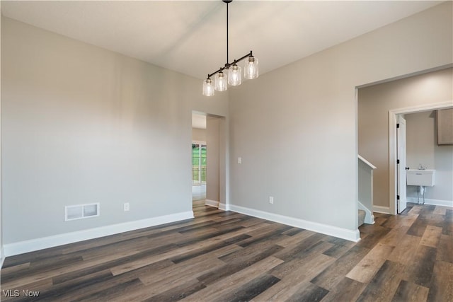 8452 Beatty St NW, Massillon, OH 44646 - unfurnished room with dark wood-type flooring and stairs