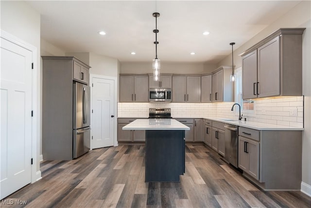 8452 Beatty St NW, Massillon, OH 44646 - kitchen featuring stainless steel appliances, gray cabinetry, a center island, decorative backsplash, and recessed lighting