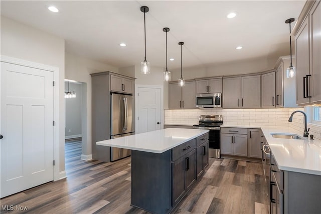 8452 Beatty St NW, Massillon, OH 44646 - kitchen with stainless steel appliances, gray cabinets, a center island, tasteful backsplash, and recessed lighting