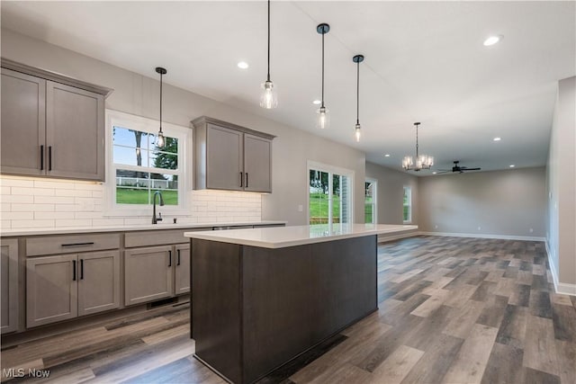 8452 Beatty St NW, Massillon, OH 44646 - kitchen featuring a chandelier, backsplash, healthy amount of natural light, light countertops, and recessed lighting
