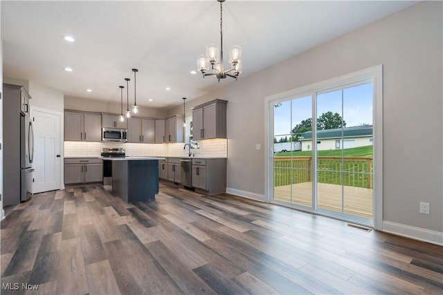 8452 Beatty St NW, Massillon, OH 44646 - kitchen with stainless steel appliances, gray cabinetry, tasteful backsplash, recessed lighting, and dark wood finished floors
