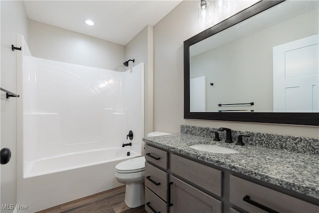 8452 Beatty St NW, Massillon, OH 44646 - full bath with wood finished floors, vanity, and washtub / shower combination