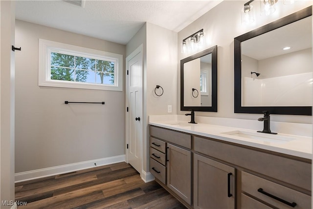 8452 Beatty St NW, Massillon, OH 44646 - bathroom featuring double vanity, wood finished floors, and a shower