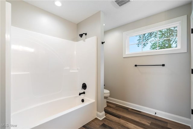 8452 Beatty St NW, Massillon, OH 44646 - bathroom with bathtub / shower combination, wood finished floors, and recessed lighting