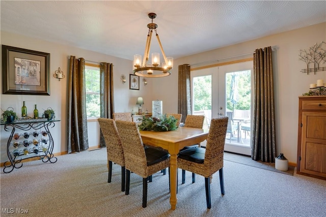 2939 Sandhill Rd, Marietta, OH 45750 - dining space featuring light carpet, a chandelier, and french doors