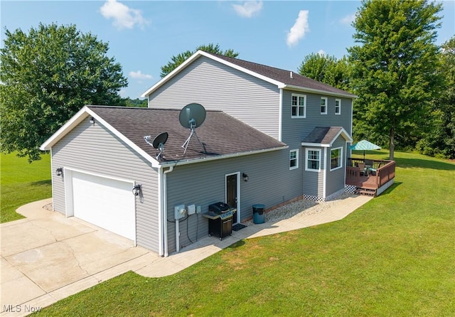 2939 Sandhill Rd, Marietta, OH 45750 - rear view of property featuring a wooden deck, an attached garage, a shingled roof, a yard, and concrete driveway