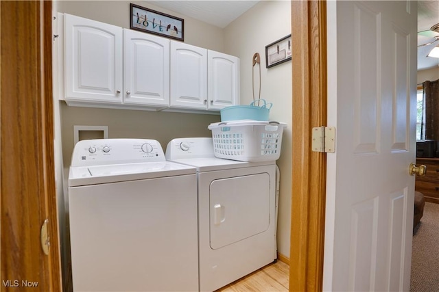 2939 Sandhill Rd, Marietta, OH 45750 - laundry area with cabinet space, washer and clothes dryer, and light wood-style flooring