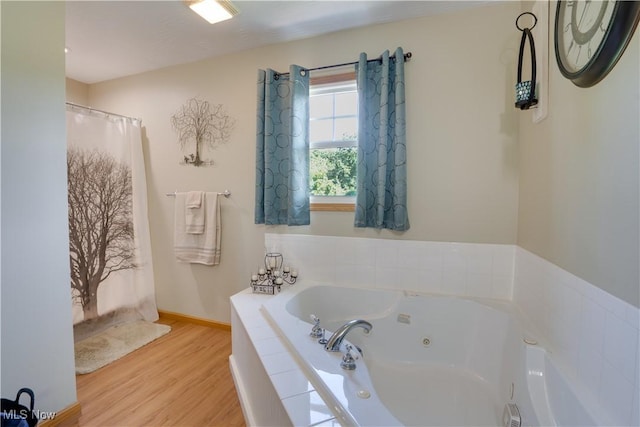 2939 Sandhill Rd, Marietta, OH 45750 - full bathroom with wood finished floors and a jetted tub