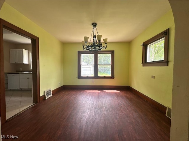 1012 Chandler Ave, Akron, OH 44314 - spare room with dark wood finished floors and a chandelier