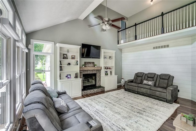 18367 Cranberry Ridge Ln, Chagrin Falls, OH 44023 - living room with dark wood-type flooring, a ceiling fan, a glass covered fireplace, wooden walls, and high vaulted ceiling