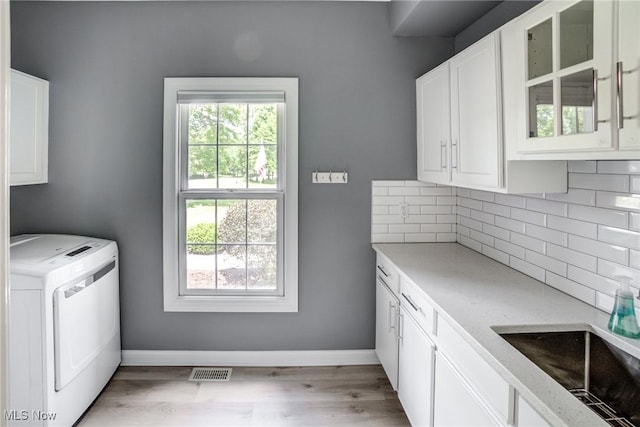 18367 Cranberry Ridge Ln, Chagrin Falls, OH 44023 - washroom with cabinet space, washer / clothes dryer, healthy amount of natural light, and light wood-type flooring