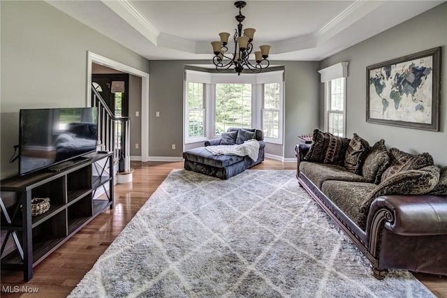 18367 Cranberry Ridge Ln, Chagrin Falls, OH 44023 - living area featuring a tray ceiling, wood finished floors, a chandelier, plenty of natural light, and ornamental molding