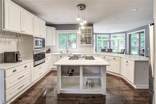 18367 Cranberry Ridge Ln, Chagrin Falls, OH 44023 - kitchen featuring stainless steel appliances, a peninsula, open shelves, light countertops, and backsplash