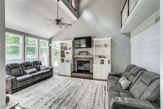 18367 Cranberry Ridge Ln, Chagrin Falls, OH 44023 - living area featuring a ceiling fan, wood finished floors, a glass covered fireplace, and high vaulted ceiling