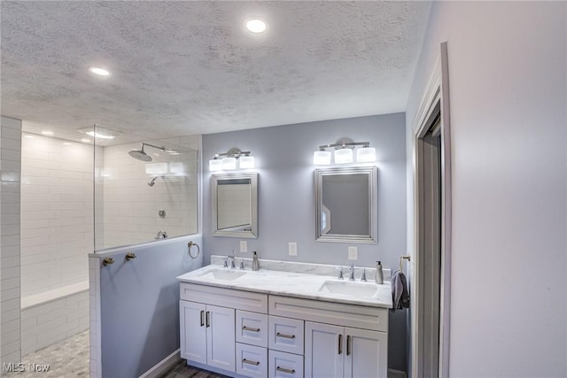 18367 Cranberry Ridge Ln, Chagrin Falls, OH 44023 - full bathroom with double vanity, walk in shower, a textured ceiling, and recessed lighting