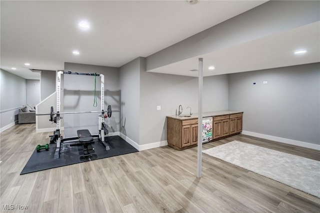 18367 Cranberry Ridge Ln, Chagrin Falls, OH 44023 - exercise room with bar with sink, light wood-type flooring, and recessed lighting