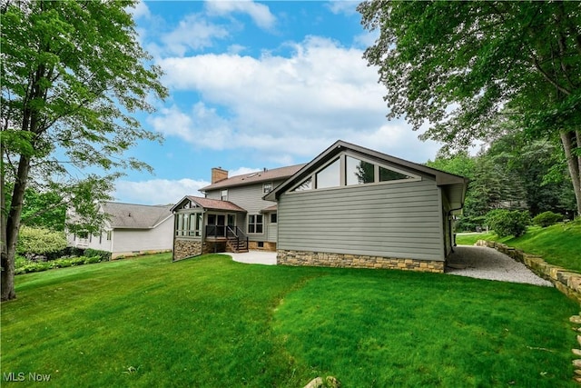 5835 Garth Cir NW, Canton, OH 44718 - back of property featuring a lawn and a sunroom