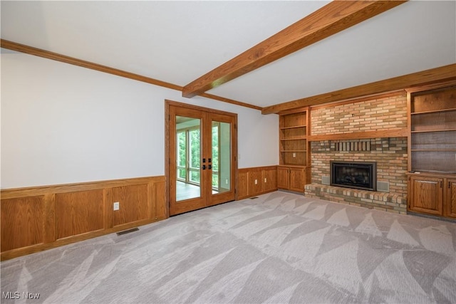 5835 Garth Cir NW, Canton, OH 44718 - unfurnished living room with a wainscoted wall, built in features, french doors, beamed ceiling, and carpet flooring