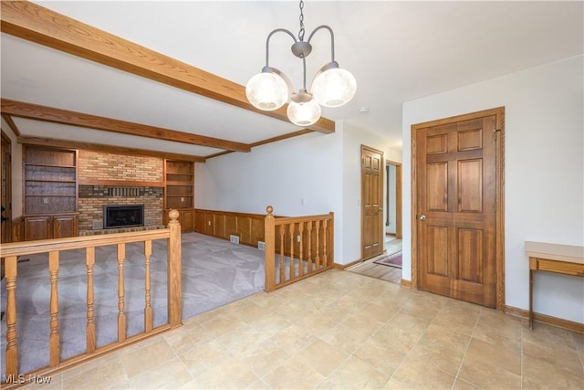 5835 Garth Cir NW, Canton, OH 44718 - unfurnished living room with a chandelier, beam ceiling, a brick fireplace, light carpet, and built in shelves