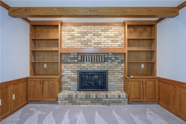 5835 Garth Cir NW, Canton, OH 44718 - unfurnished living room featuring light colored carpet, wainscoting, built in features, a brick fireplace, and wooden walls