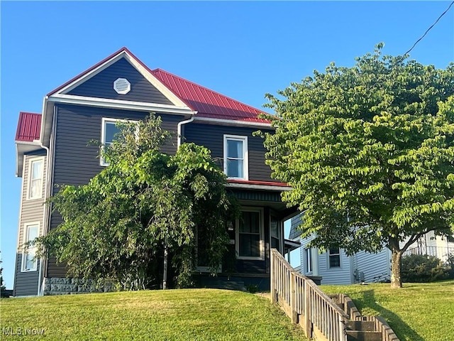 423 W Main St, Barnesville, OH 43713 - view of front of home featuring a front yard and a metal roof