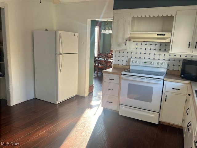 423 W Main St, Barnesville, OH 43713 - kitchen with white appliances, under cabinet range hood, light countertops, and dark wood-type flooring