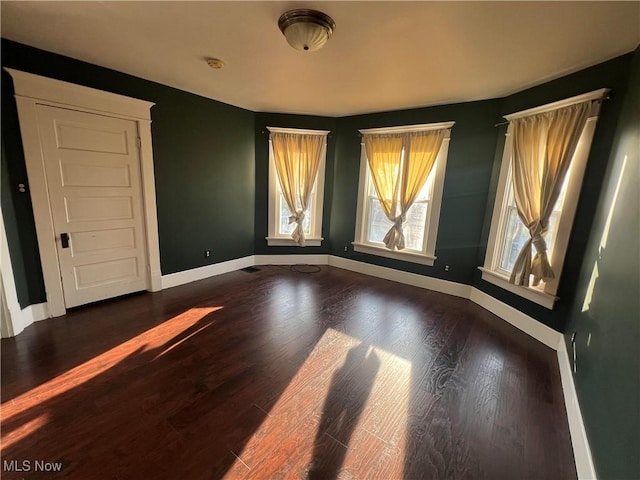 423 W Main St, Barnesville, OH 43713 - empty room with baseboards and dark wood-style flooring