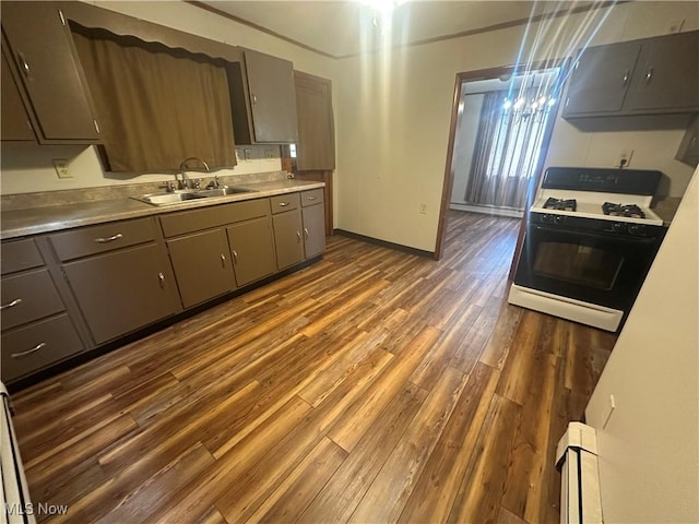 600 Jeanette Ave, Martins Ferry, OH 43935 - kitchen featuring gas stove, gray cabinetry, dark wood finished floors, and a chandelier