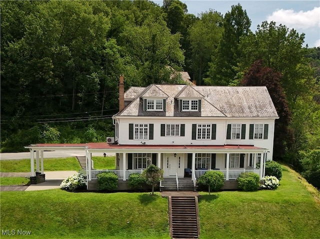 12 Lotus Ave, Chester, WV 26034 - view of front of home with a porch, a chimney, and a front lawn