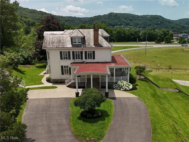 12 Lotus Ave, Chester, WV 26034 - view of front of property featuring driveway, a view of trees, stucco siding, and a chimney