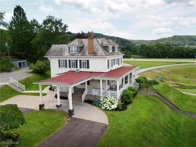12 Lotus Ave, Chester, WV 26034 - view of front of house featuring a porch, driveway, a chimney, and a front yard