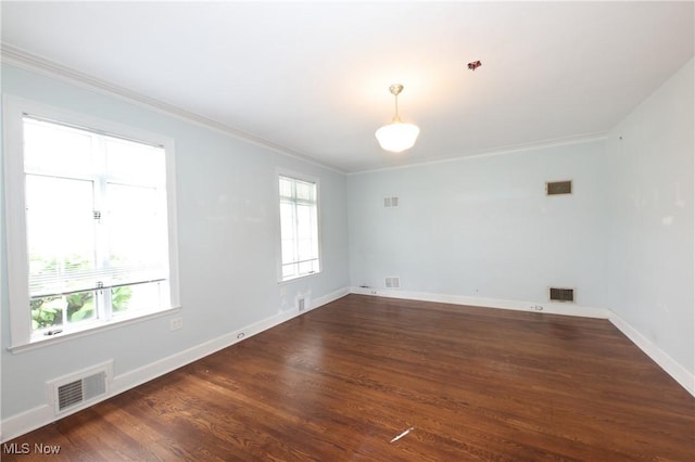 12 Lotus Ave, Chester, WV 26034 - empty room featuring healthy amount of natural light, crown molding, and dark wood-type flooring