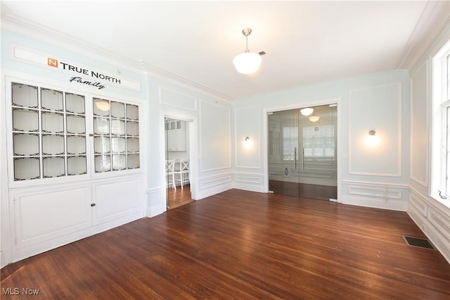 12 Lotus Ave, Chester, WV 26034 - empty room featuring a decorative wall, wood finished floors, and ornamental molding