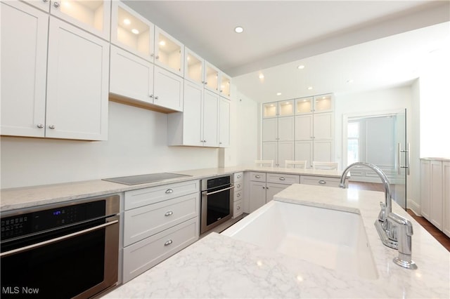 12 Lotus Ave, Chester, WV 26034 - kitchen featuring oven, black electric stovetop, white cabinetry, and recessed lighting