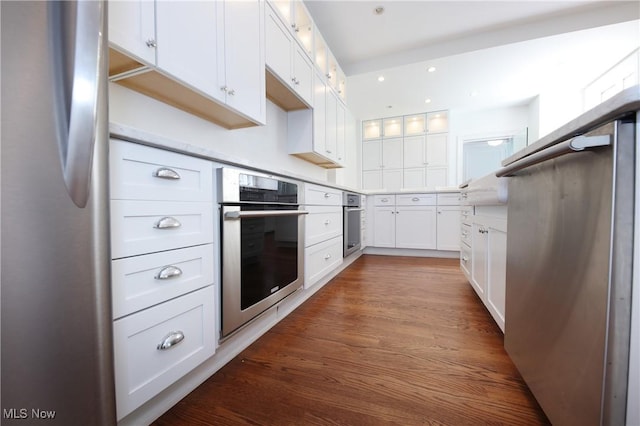 12 Lotus Ave, Chester, WV 26034 - kitchen with appliances with stainless steel finishes, white cabinets, glass insert cabinets, dark wood-style flooring, and light countertops