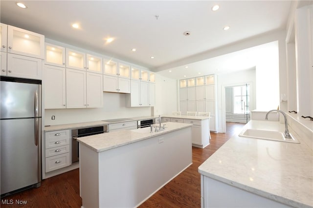 12 Lotus Ave, Chester, WV 26034 - kitchen with appliances with stainless steel finishes, a center island, dark wood-style flooring, light stone counters, and recessed lighting