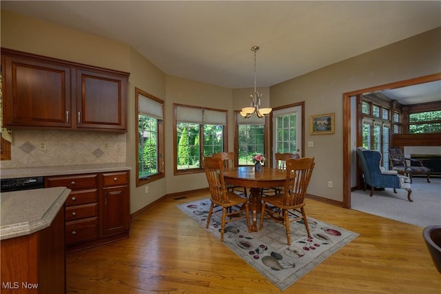 1110 Mansion Dr, Barberton, OH 44203 - dining area with a chandelier and light wood-type flooring