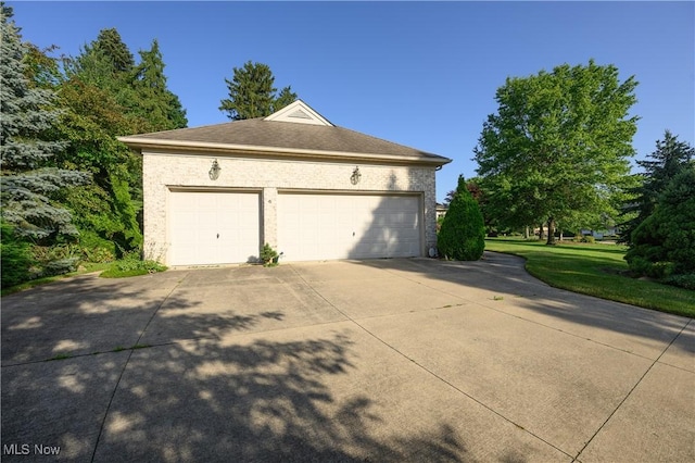 1110 Mansion Dr, Barberton, OH 44203 - view of property exterior with a garage, driveway, and a yard