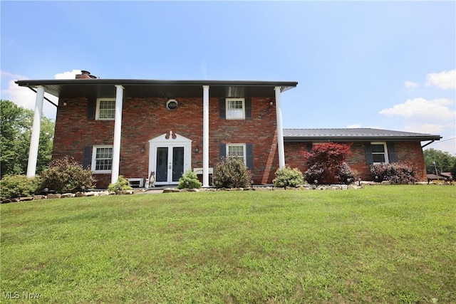 27 Robinson Ln, Weirton, WV 26062 - view of front facade with french doors, a chimney, brick siding, and a front lawn