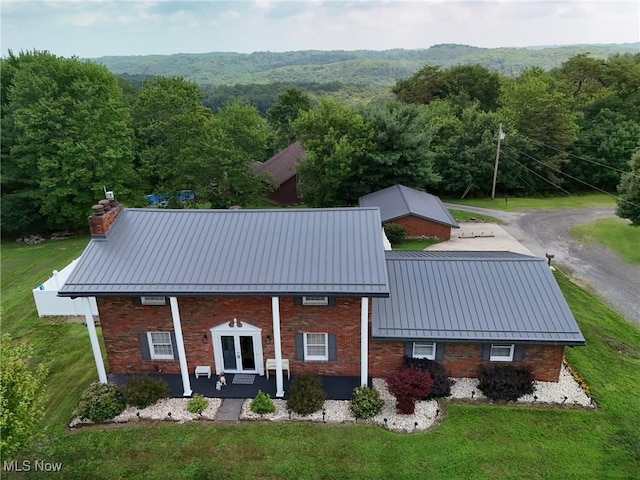 27 Robinson Ln, Weirton, WV 26062 - back of house with a chimney, a standing seam roof, and a forest view