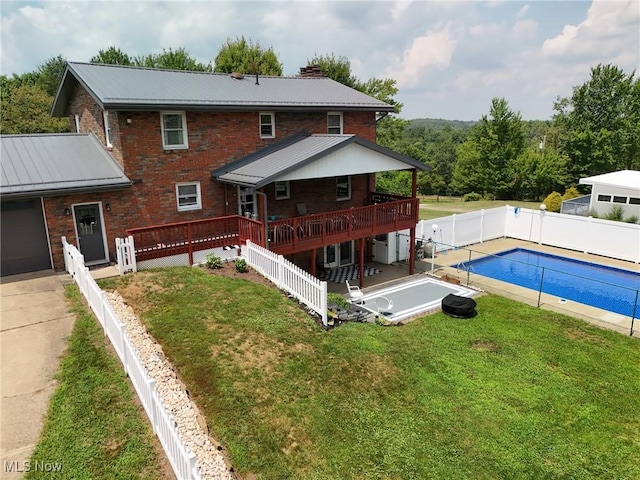 27 Robinson Ln, Weirton, WV 26062 - back of property featuring brick siding, a wooden deck, a metal roof, and a fenced backyard