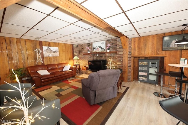 27 Robinson Ln, Weirton, WV 26062 - living room with wood walls, wood finished floors, a drop ceiling, and a fireplace