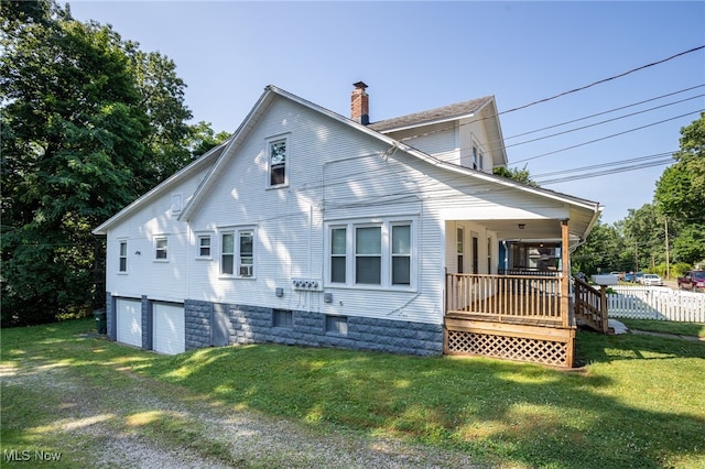 1333 Meriline St, Cuyahoga Falls, OH 44221 - back of property featuring a chimney, an attached garage, and covered porch