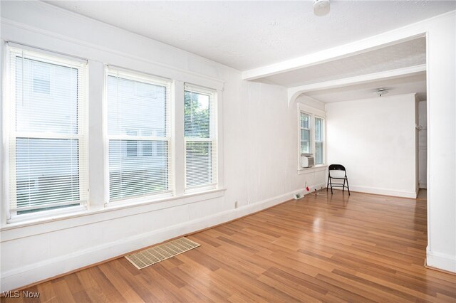 1333 Meriline St, Cuyahoga Falls, OH 44221 - spare room with wood finished floors, beamed ceiling, and cooling unit
