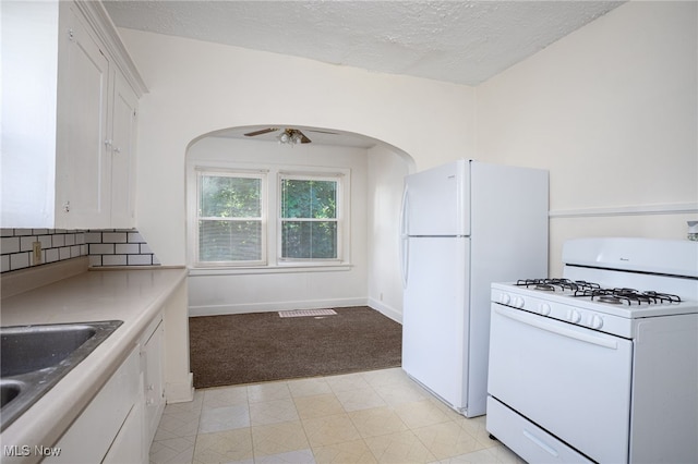 1333 Meriline St, Cuyahoga Falls, OH 44221 - kitchen featuring white appliances, white cabinets, light carpet, arched walkways, and a textured ceiling