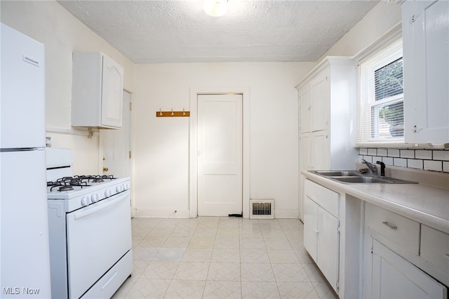 1333 Meriline St, Cuyahoga Falls, OH 44221 - kitchen with white appliances, a textured ceiling, white cabinetry, light countertops, and backsplash