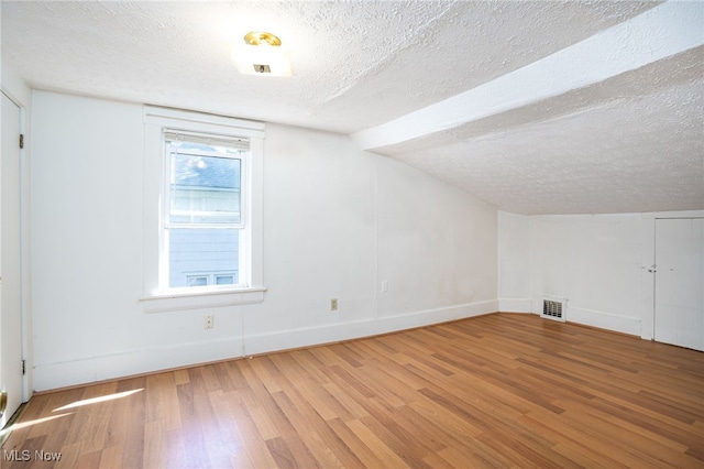 1333 Meriline St, Cuyahoga Falls, OH 44221 - bonus room featuring wood finished floors, a textured ceiling, and lofted ceiling