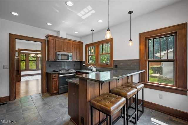 159 Edgerton Rd, Akron, OH 44303 - kitchen featuring stainless steel appliances, plenty of natural light, a peninsula, a kitchen bar, and recessed lighting