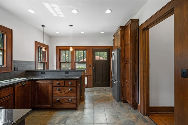 159 Edgerton Rd, Akron, OH 44303 - kitchen with freestanding refrigerator, dark stone counters, pendant lighting, recessed lighting, and tasteful backsplash